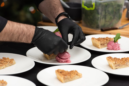 chief serving slice of apple pie and sorbetの写真素材