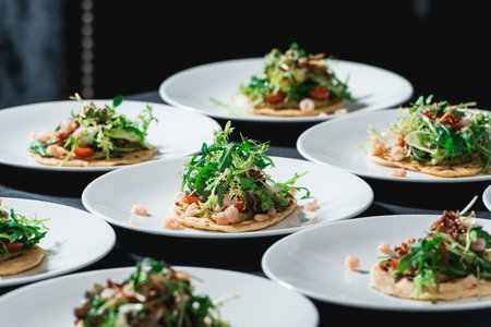 Set of spicy shrimp tacos with coleslaw and salsa served in a restaurantの写真素材
