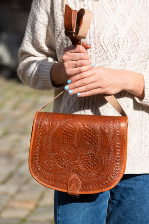 small light brown womens leather bag with a carved pattern. street photoの写真素材