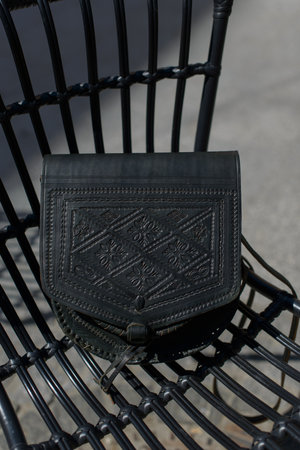 small black womens leather bag with a carved pattern. selective focusの写真素材