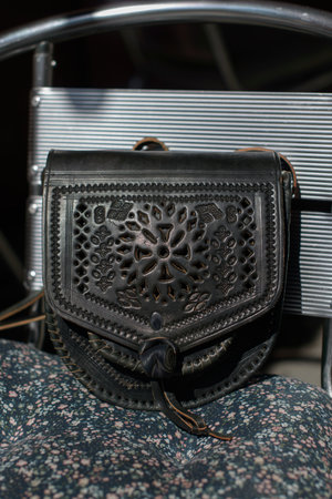small black womens leather bag with a carved pattern. selective focusの写真素材