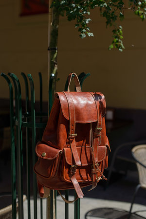 Orange leather oldfashioned backpack on a metal gridの写真素材