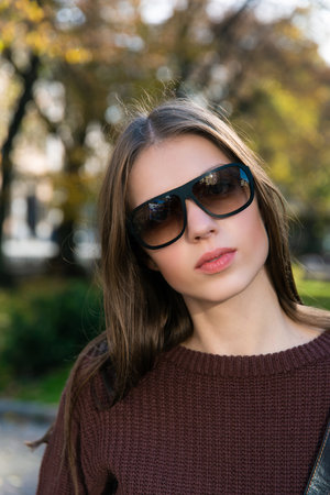 Close up shot of stylish young woman in sunglasses at the street. Beautiful female modelの写真素材