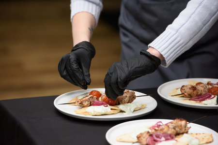 the chef in the restaurant prepares souvlaki with pita and tzatziki sauceの写真素材