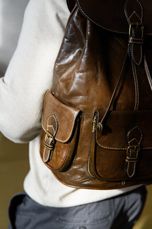 Olive leather oldfashioned backpack on a mans backの写真素材