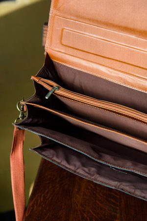 close-up photo of open orange leather bag corporate.