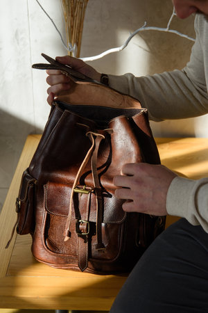 brown leather oldfashioned backpack. indoors photoの写真素材