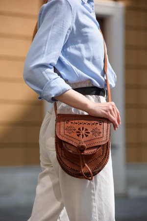 small light brown womens leather bag with a carved pattern. selective focusの写真素材