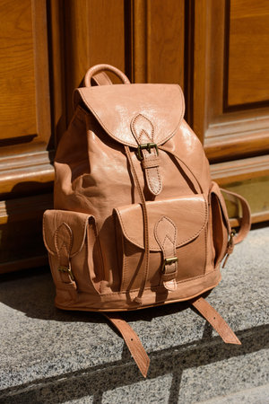 beige leather oldfashioned backpack. outdoors photoの写真素材