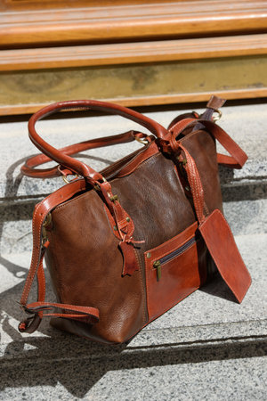 brown female leather bag. street photoの写真素材