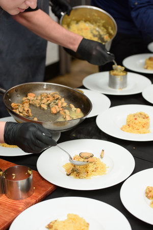 preparation of paella with chicken and musselsの写真素材