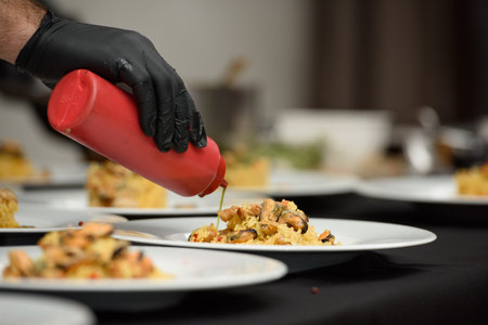 preparation of paella with chicken and musselsの写真素材