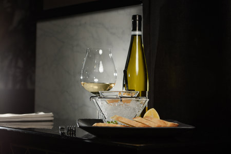Pike fish caviar, on ice, with croutons, lemon, on a transparent dish, on a dark backgroundの写真素材