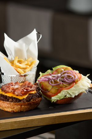 fresh tasty burger and french fries on wooden deskの写真素材