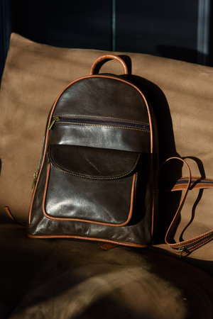 Brown leather backpack on chair, close up.の写真素材