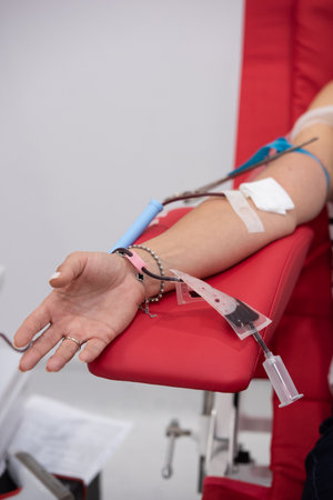 view of donor giving blood at donation centerの写真素材