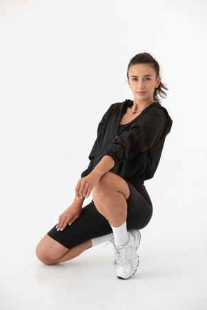 Young athlete girl posing in a black leggings and shirt. indoorsの写真素材