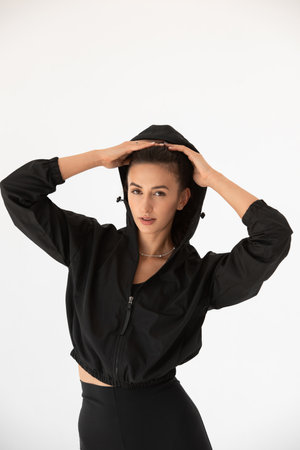 Young athlete girl posing in a black leggings and shirt. indoorsの写真素材