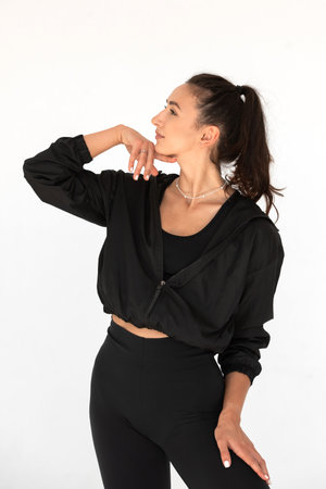 Young athlete girl posing in a black leggings and shirt. indoorsの写真素材