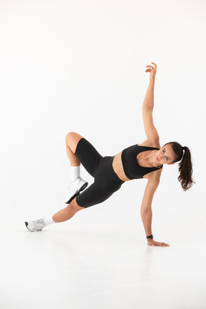 Smiling healthy woman doing yoga at home. white backgroundの写真素材