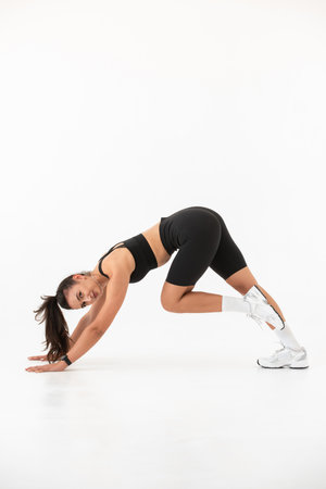 Smiling healthy woman doing yoga at home. white backgroundの写真素材