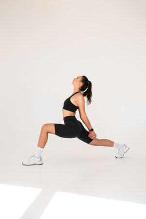 Smiling healthy woman doing yoga at home. white backgroundの写真素材