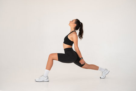 Smiling healthy woman doing yoga at home. white backgroundの写真素材