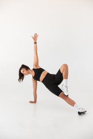 Smiling healthy woman doing yoga at home. white backgroundの写真素材