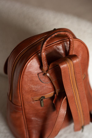 photo of a orange leather backpack with retro look. indoors photoの写真素材