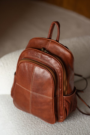 photo of a orange leather backpack with retro look. indoors photoの写真素材