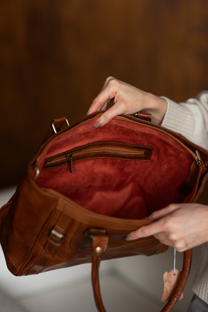 photo of a orange leather bag with retro look. indoors photoの写真素材