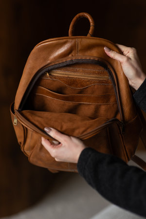 photo of a brown leather backpack with retro look. indoors photo