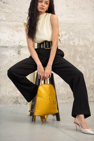 A Chic Outfit Featuring a Bright Yellow Backpack Paired with Stylish and Trendy Footwear