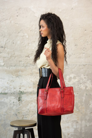 A Chic Outfit Featuring a Bright Red Bag Paired with Stylish and Trendy Blouse and Pantsの写真素材