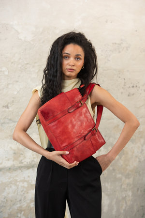 A Chic Outfit Featuring a Bright Red Bag Paired with Stylish and Trendy Blouse and Pantsの写真素材