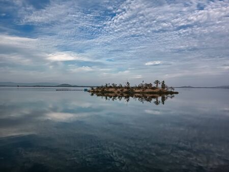 Island in the ocean with clouds on mansoon day. Landscape backgroundの写真素材