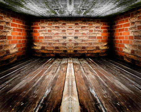 Empty vintage room interior, wooden floor, red brick wall and concrete ceiling.の写真素材