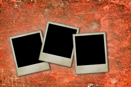 Old blank photos frames lying on a concrete wall surface for text and photoの写真素材