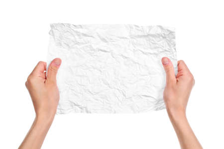 Hands and crumpled paper isolated on white backgroundの写真素材