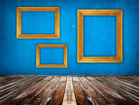 blue empty room with wooden floor and empty frame hanging on the wallの写真素材