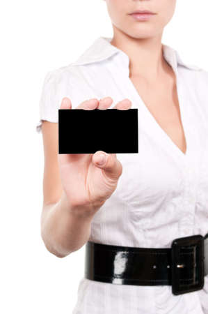 Woman showing business card. Young female professional executive smiling in white suit - closeup of business card.の写真素材
