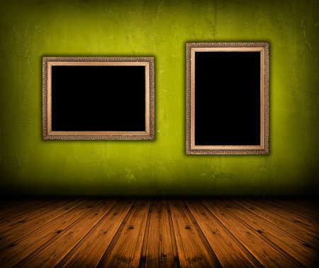 vintage green interior with empty frame hanging on the wallの写真素材