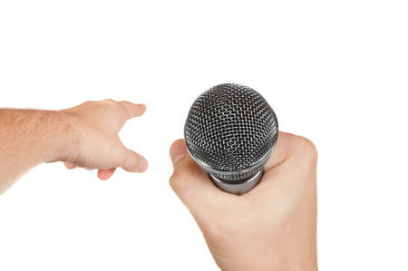 Microphone in a hand and other hand pointing forward isolated on white backgroundの写真素材