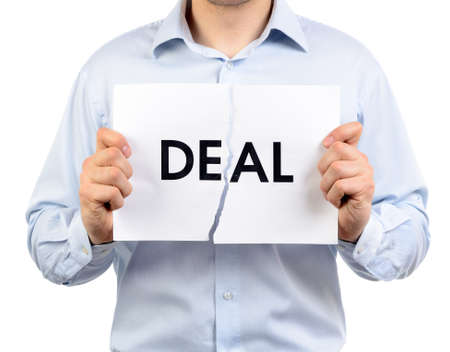 Man holding a torn paper which says 