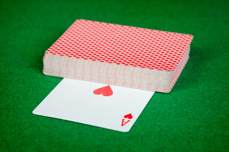 Deck of cards on green surfaceの写真素材