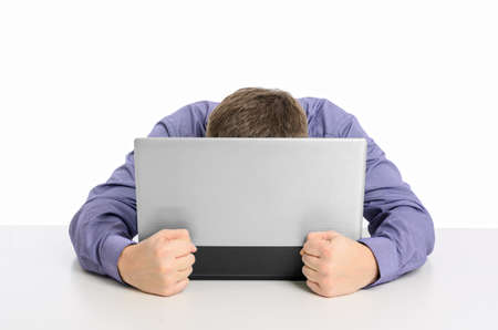 Man frustrated with his laptop computer isolated on white backgroundの写真素材