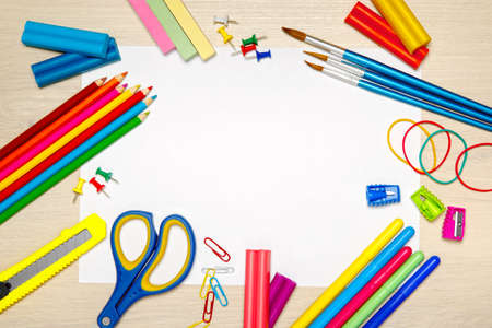 School supplies with blank paper on the school desk