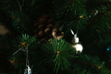 Christmas cones on the background of branches and needles of an artificial Christmas tree, close-up