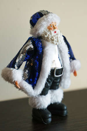 Christmas figurine of Santa Claus in blue clothes made of sequins, close-up photoの写真素材