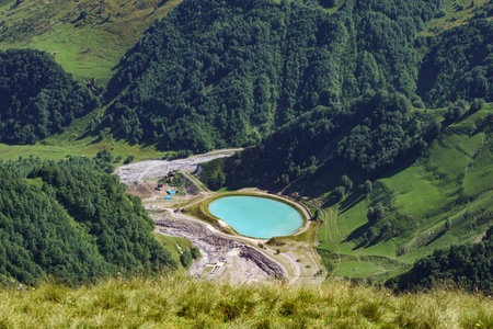 View from the green mountain to the blue round lake. Round lake in the gorge near the Monument of Friendship of Peoples, Georgiaの写真素材
